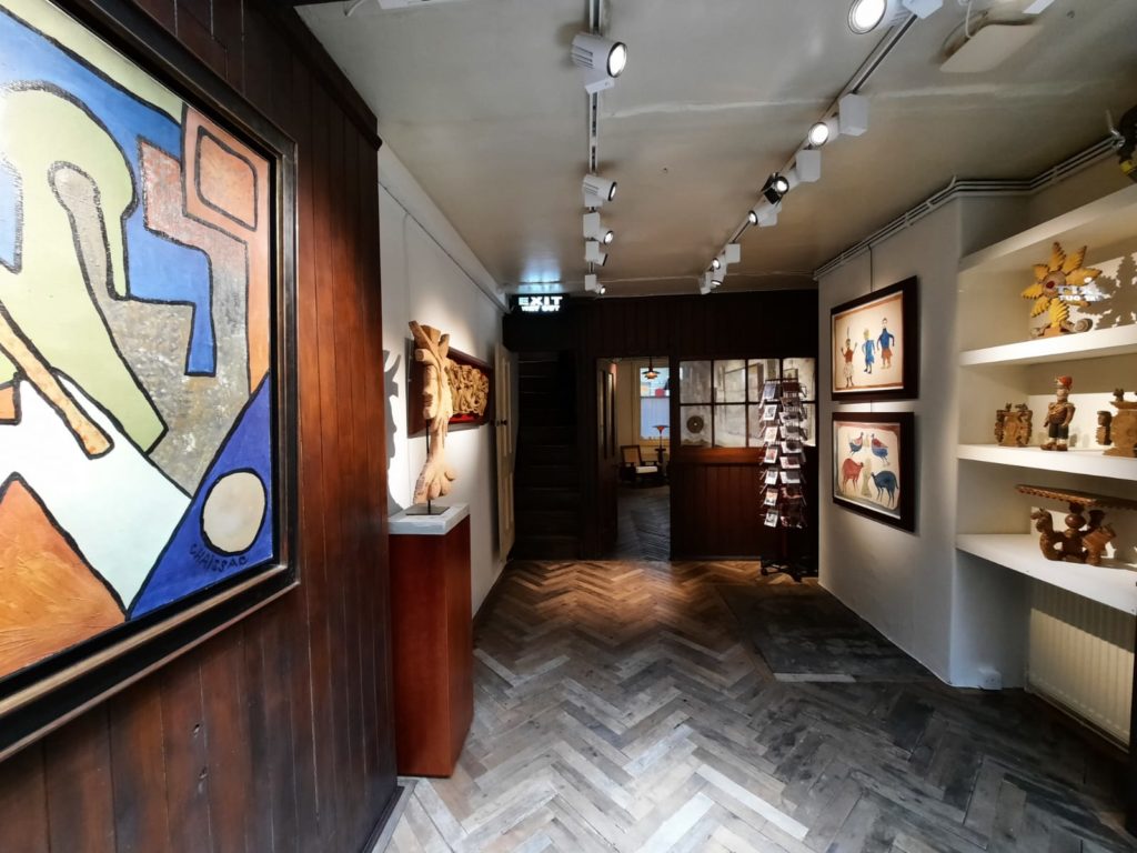 An image of the basement of the Gallery of Everything, with a range of Art Brut artworks on display.