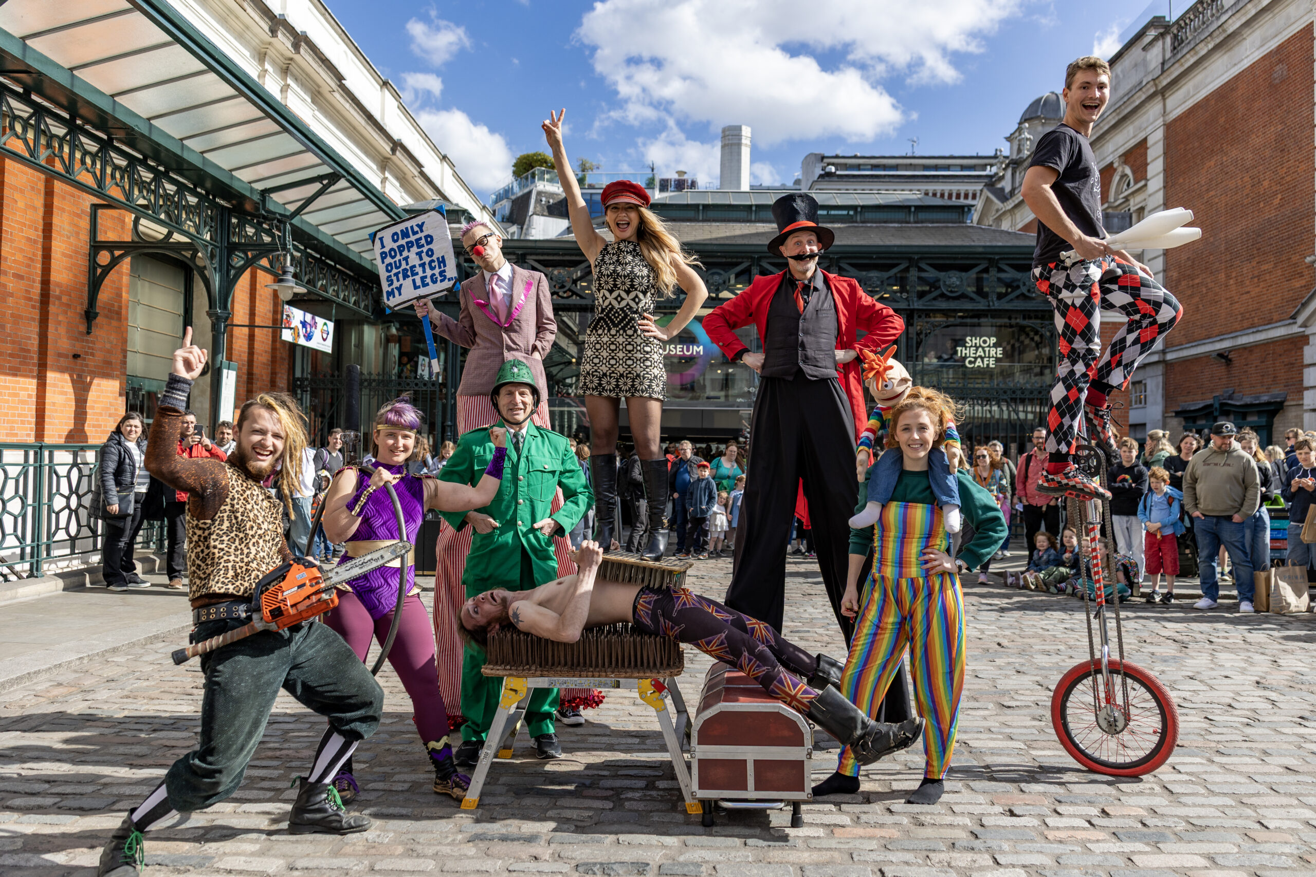 A colourful group of street performers post in Covent Garden